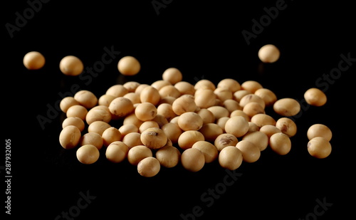 Organic raw soybeans, soy isolated on black background