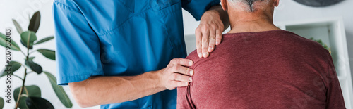 panoramic shot of doctor touching shoulder of man © LIGHTFIELD STUDIOS