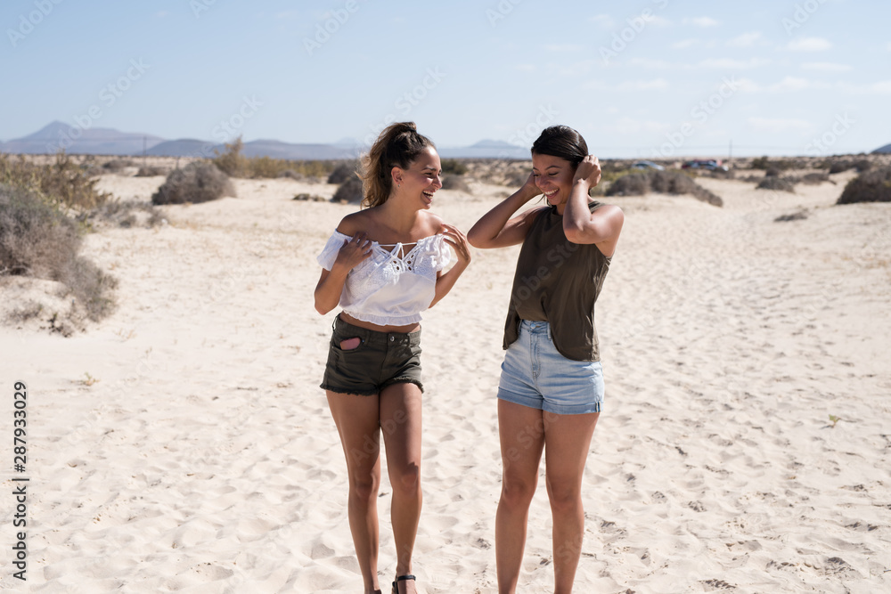 Two young girls walking along the beach Two young girls walking along the beach