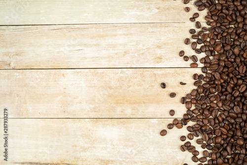 Coffee beans frame with beans at the right side on a oak background