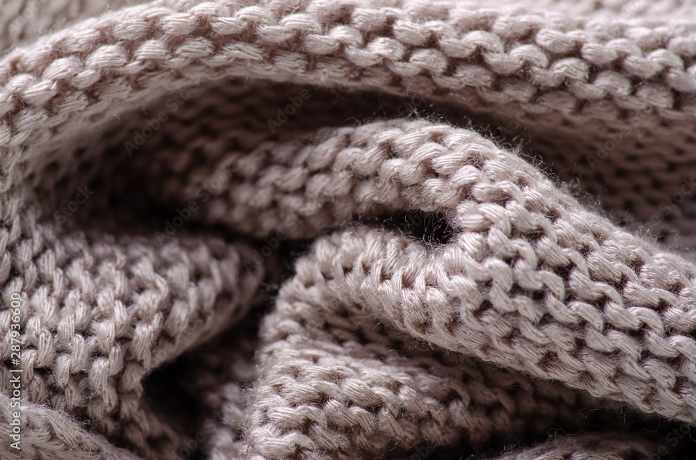 Beige warm knited material fabric sweater texture blur background Beige warm knited material fabric sweater texture blur background