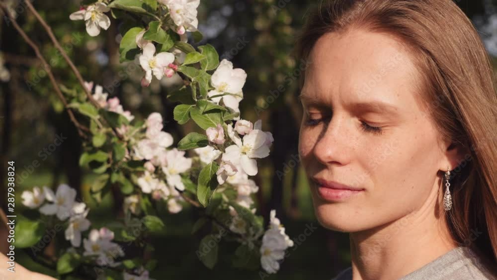 Beautiful сaucasian girl on background of blossoming tree Beautiful сaucasian girl on background of blossoming tree