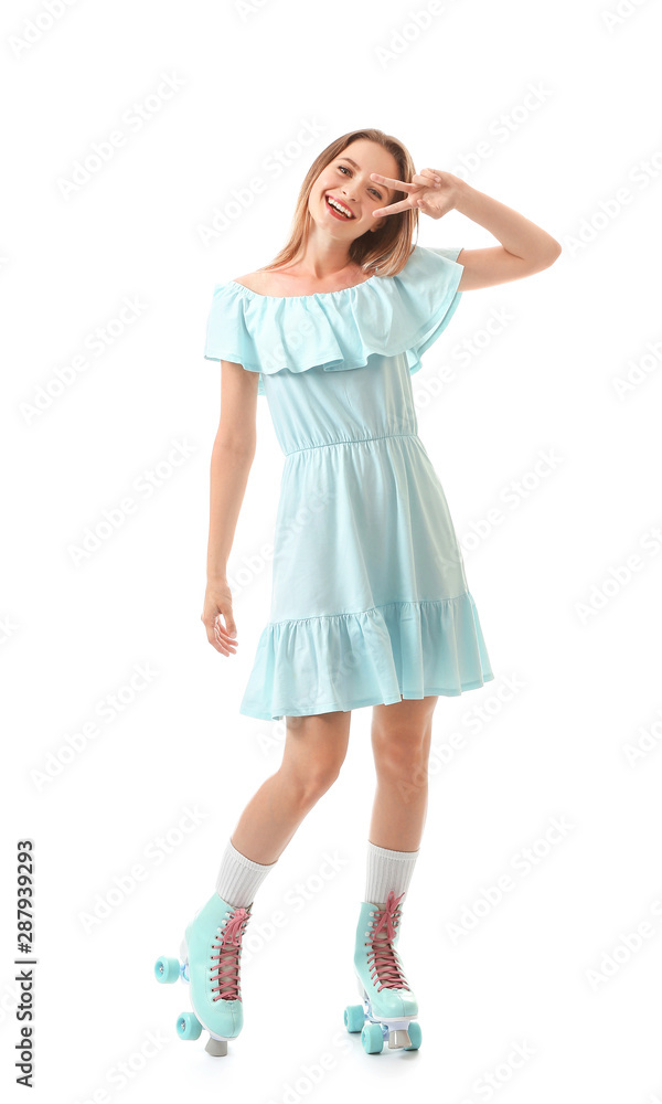 Beautiful young woman on roller skates showing victory gesture against white background Beautiful young woman on roller skates showing victory gesture against white background