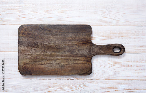 Cutting board on the wooden background. Top view.