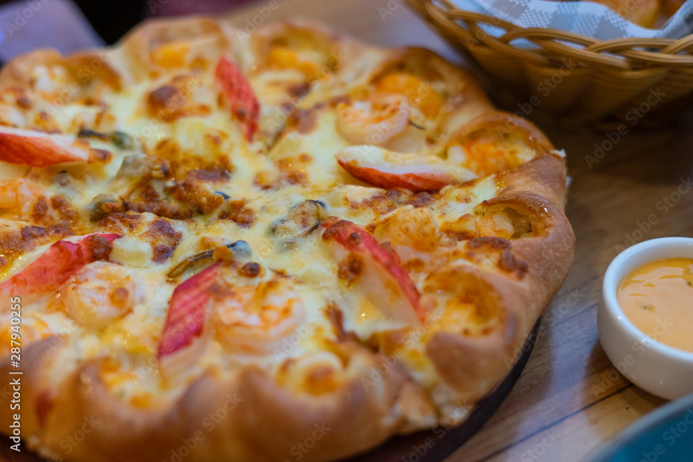 Thai chicken trio pizza on wooden background Thai chicken trio pizza on wooden background