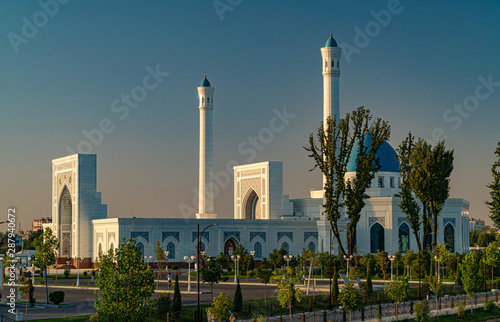 A big beautiful Mosque (Islamic temple) at sunrise over blue sky