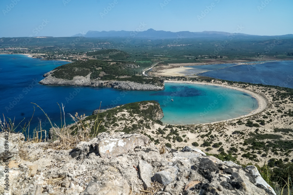 Obraz premium Panoramic aerial view of voidokilia beach, one of the best beaches in mediterranean Europe, beautiful lagoon of Voidokilia from a high point of view, Messinia, Greece