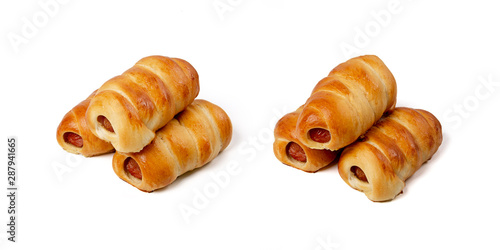 Group of freshly baked sausages in the dough isolated on white background
