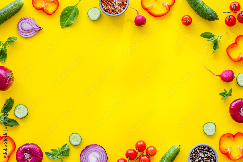 Cook frame with fresh vegetables on yellow background top view space for text