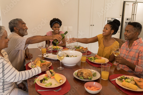 Multi-generation family having meal together on dining table