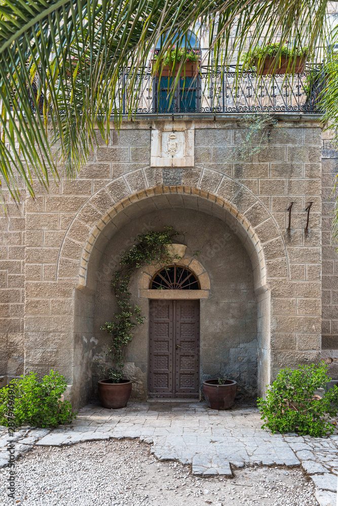 The main entrance to the monastery building on the territory of the catholic Christian Transfiguration Church located on Mount Tavor near Nazareth in Israel