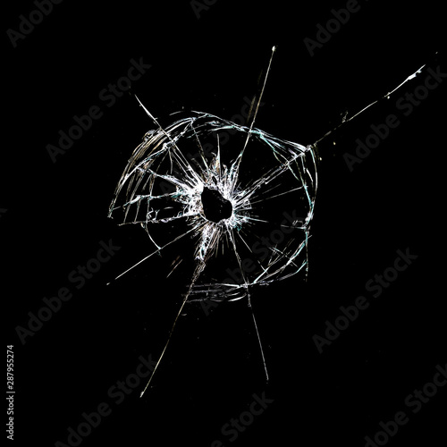 Photography hole with cracks in the glass isolated on a black