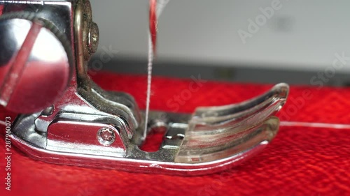 Sewing machine makes a seam macro shot photo