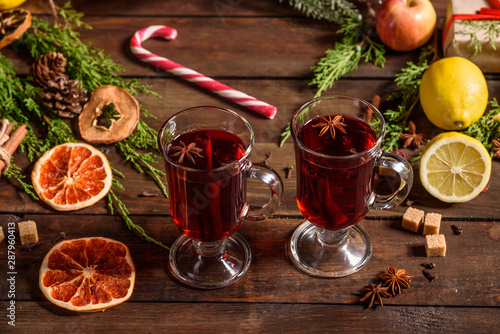 Fototapeta Naklejka Na Ścianę i Meble -  Christmas hot mulled wine with cinnamon cardamom and anise on wooden background