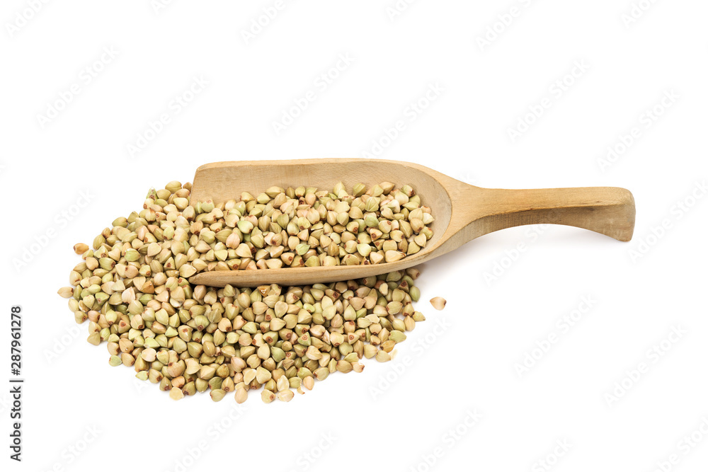 Green buckwheat in a pile and on a wooden spoon or scoop seen obliquely from above and isolated on white background Green buckwheat in a pile and on a wooden spoon or scoop seen obliquely from above and isolated on white background