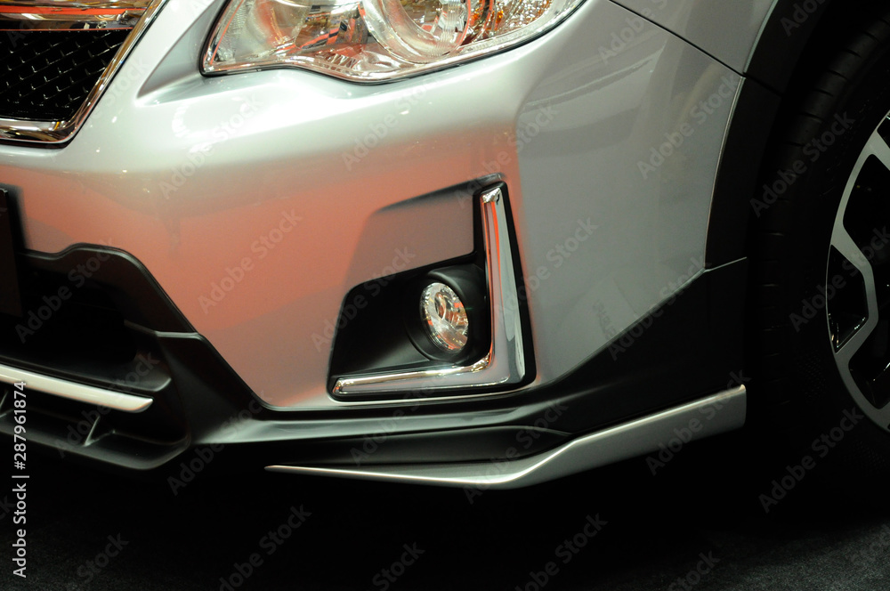 Close up of modern car front spotlight with futuristic design. Designed specifically to give more visual for the driver at night after the car head lamp.    