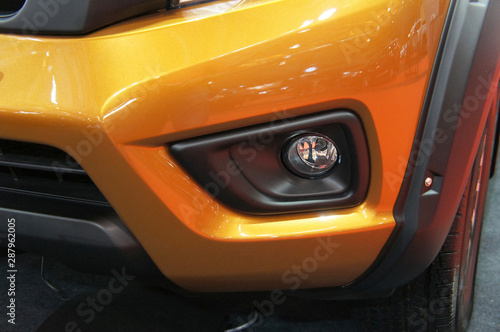 Close up of modern car front spotlight with futuristic design. Designed specifically to give more visual for the driver at night after the car head lamp. 