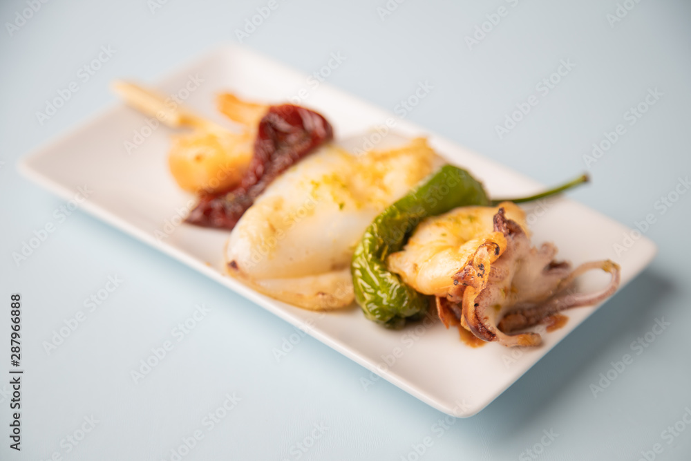 Skewer of sepia peppers and shrimp, typical Spanish tapa Skewer of sepia peppers and shrimp, typical Spanish tapa