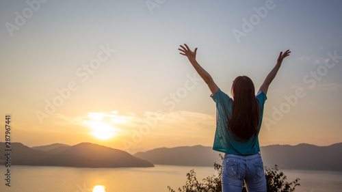 Girl in front of sunset