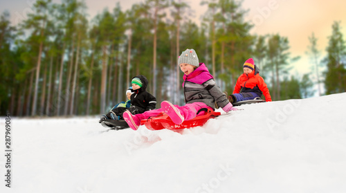 Принти на полотні childhood, sledging and season concept - group of happy little kids sliding on s