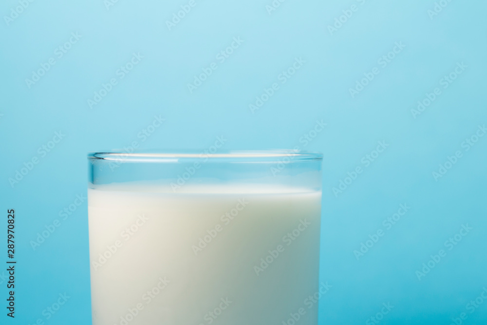 Glass milk on a blue background. source of calcium .Protein rich dairy product. healthy lifestyle concept . Glass milk on a blue background. source of calcium .Protein rich dairy product. healthy lifestyle concept .