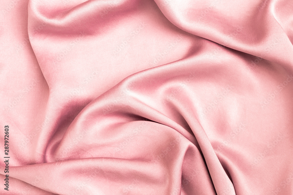 Abstract shiny pink satin fabric background, blank waving pink fabric background