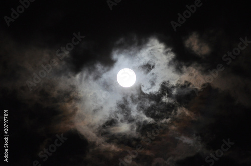 Super Full Moon with clouds at Night, Dramatic cumulus clouds in the moonlight