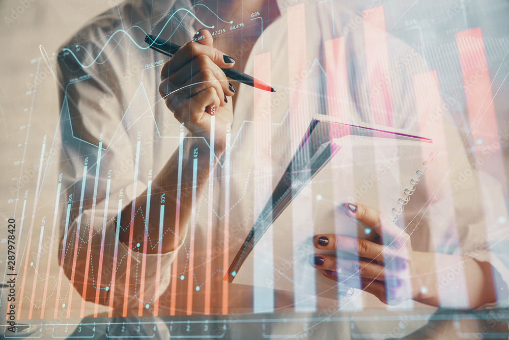 Financial chart drawn over hands taking notes background. Concept of research. Multi exposure Financial chart drawn over hands taking notes background. Concept of research. Multi exposure