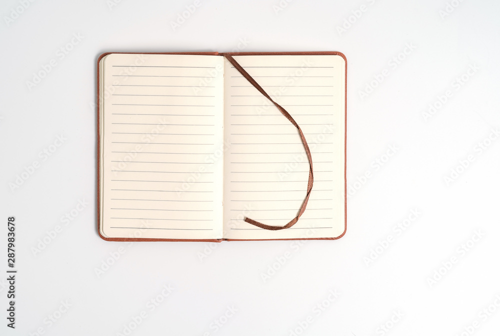 top view blank orange leather diary on white desk top view blank orange leather diary on white desk
