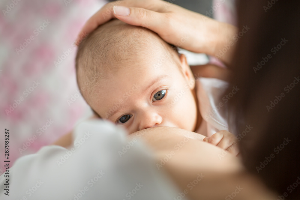 motherhood, children, people and care concept - close up of mother breastfeeding newborn baby motherhood, children, people and care concept - close up of mother breastfeeding newborn baby
