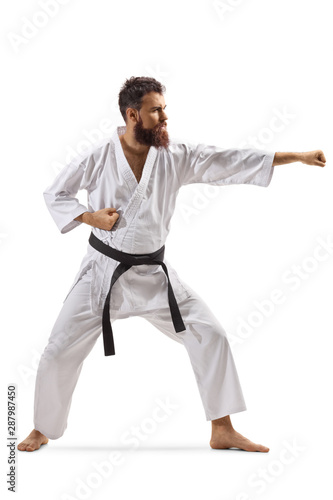 Bearded man in kimono practicing karate