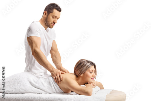 Master masseur giving a professional massage to a woman photo