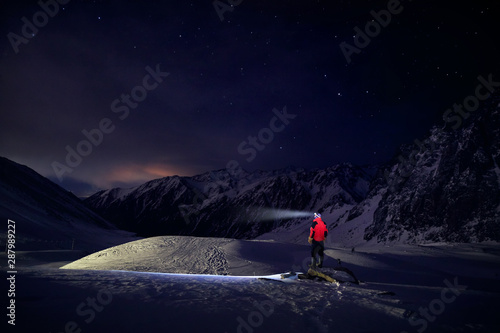 Man in mountains with night sky photo