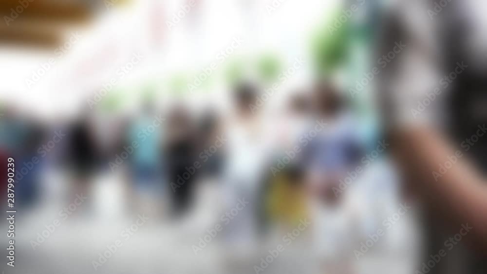 Tourists and locals walking along the pedestrian street of the old European city. 4K. Blurred view Tourists and locals walking along the pedestrian street of the old European city. 4K. Blurred view