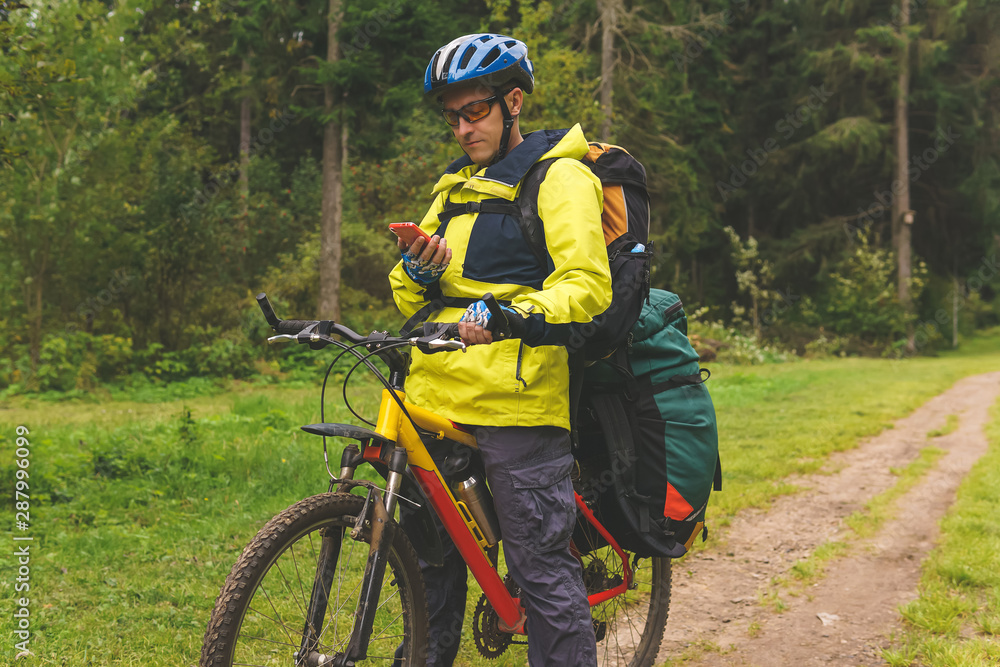 Obraz premium bikepacker is checking the route