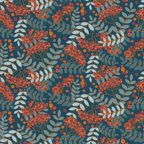 A seamless vector patter with rowan fruits and leaves on a teal background. Surface print design.