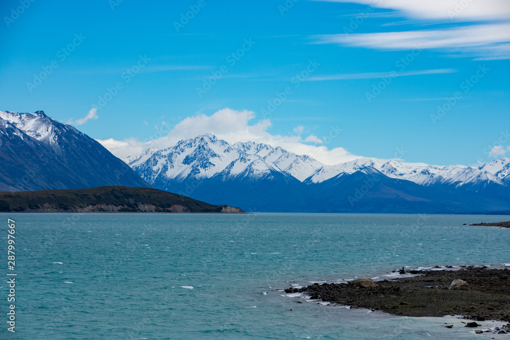 Lake Tekapo in Canterbury, New Zealand looking towards the mountains of Mt Cook/Aoraki National Park on a summer day