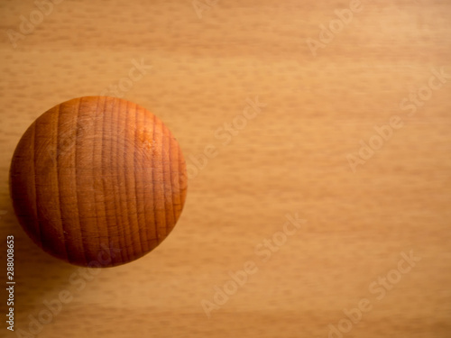 Wooden brown knob on a wooden background