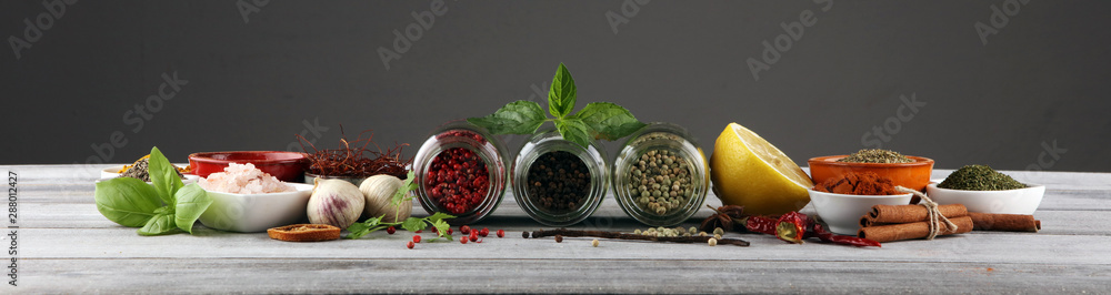 Spices and herbs on table. Food and cuisine ingredients with basil - obrazy, fototapety, plakaty 