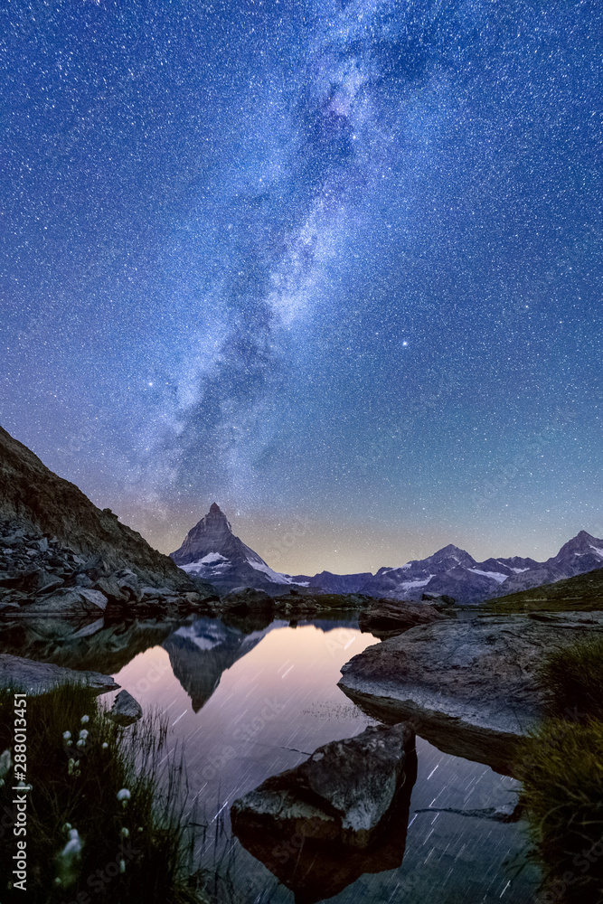 Milky way over lake Riffelsee with the reflection of the Matterhorn,  Zermatt, Switzerland