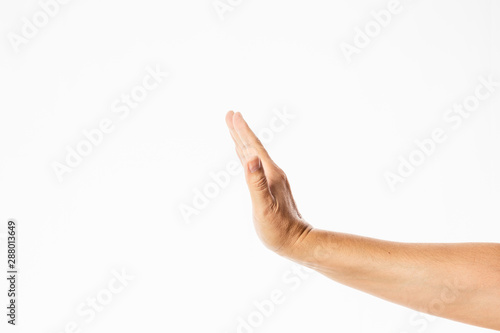 lateral view of a male hand in a holding or stop gesture isolated in a white background