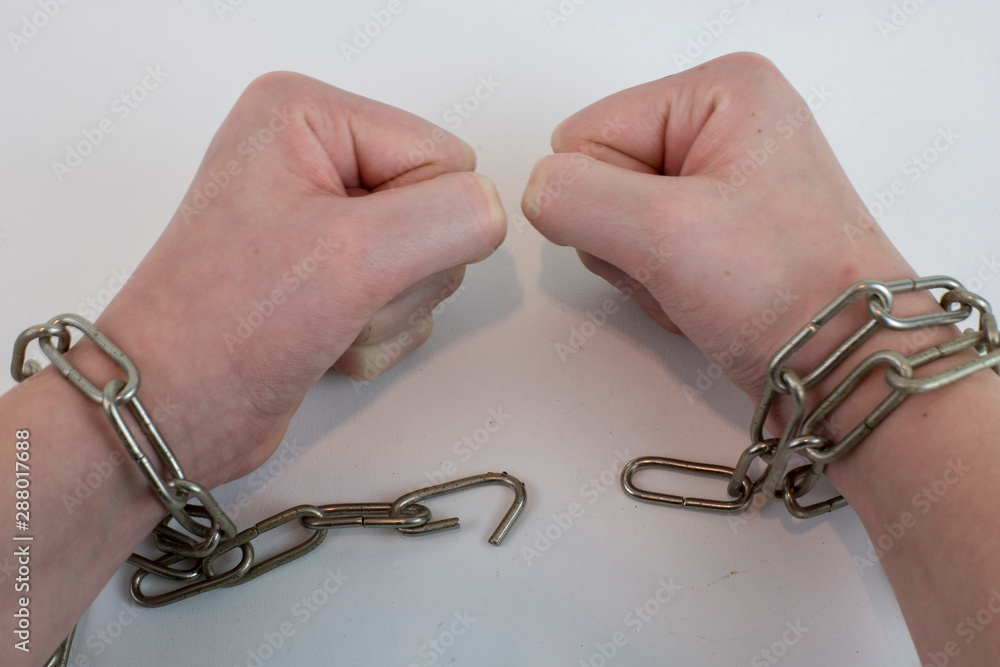 Hands chained together as an illustration to being trapped Hands chained together as an illustration to being trapped