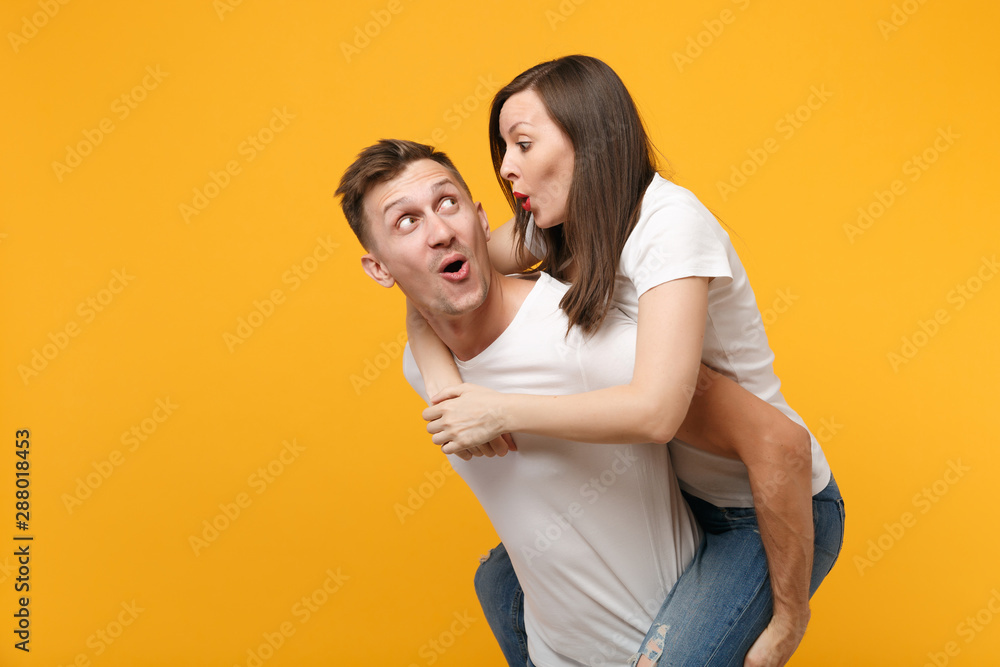 Young couple enjoying piggyback ride isolated on gray background Stock  Photo - Alamy