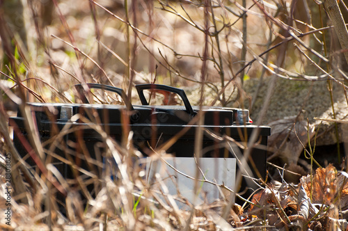 Close up_garbage_car battery_ground_branches_by jziprian