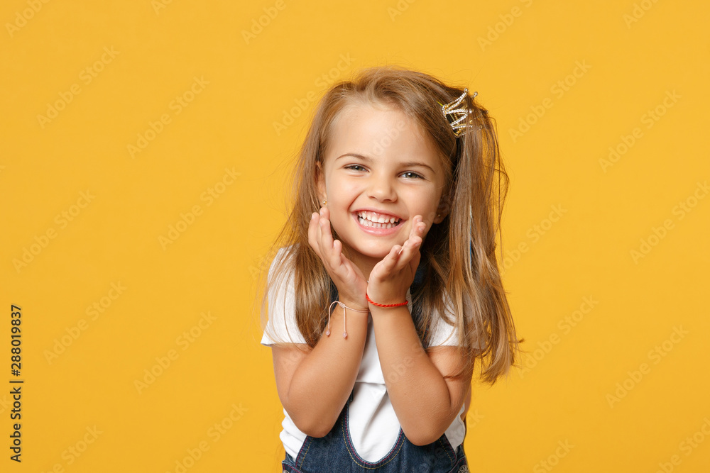 Little cute child kid baby girl 4-5 years old wearing light denim clothes  isolated on pastel yellow wall background, children studio portrait.  Mother's Day, love family, parenthood childhood concept. Stock Photo |