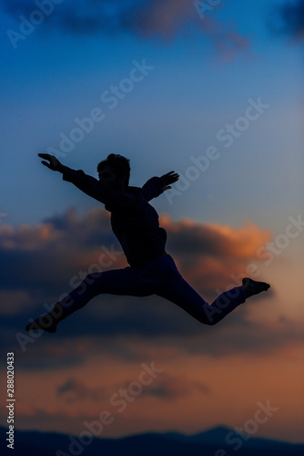 Wallpaper Mural Awesome dancer is jumping very high in the sunset sky Torontodigital.ca