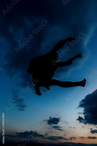 Attractive jumping woman dancer hovers in the sky © qunica.com