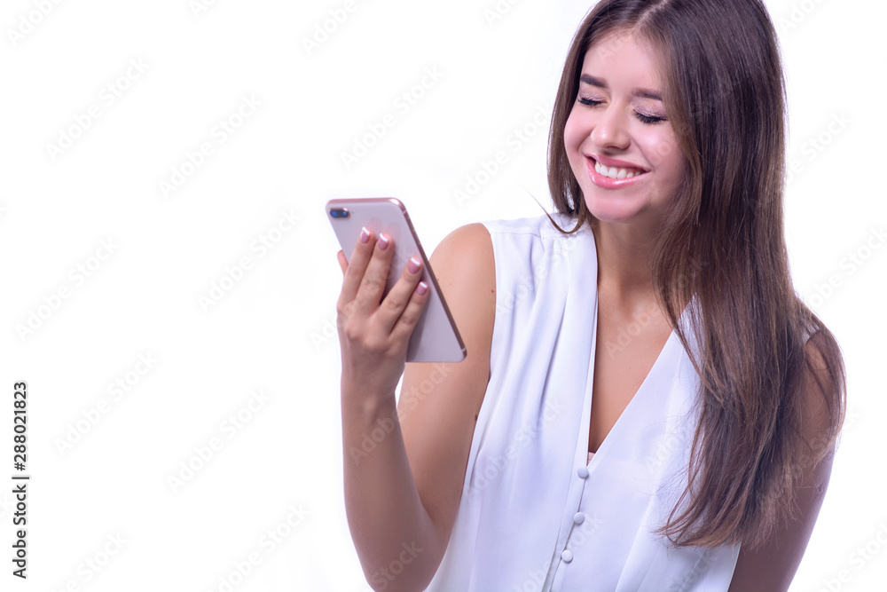 Happy girl with a smartphone in hands on a white background. A joyful message, a win, good luck. Happy girl with a smartphone in hands on a white background. A joyful message, a win, good luck.