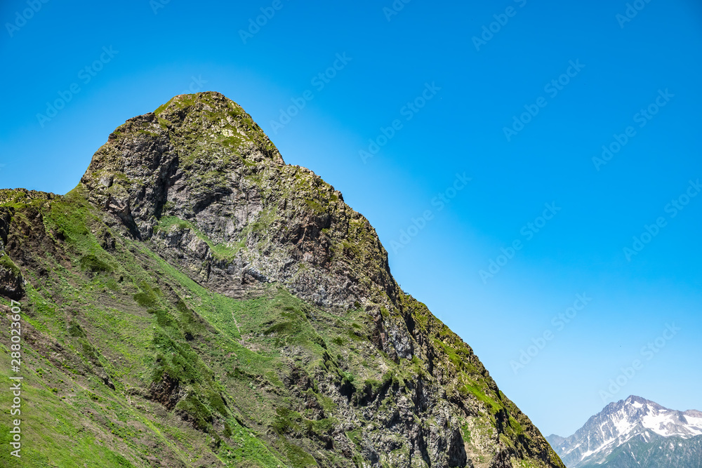 High mountain with green slope. Black Pyramid Mountain, Krasnaya Polyana, Sochi, Caucasus, Russia