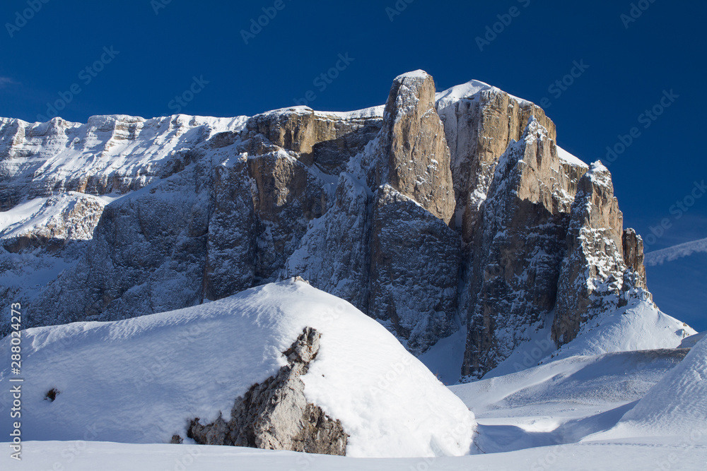 Sella Towers and the Sella Mountain in the the Alps. Winter in the Dolomites. Bright Blue Sky above Sella